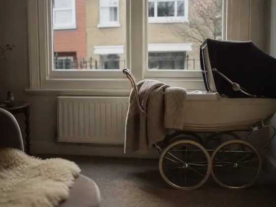 pram by a bright window, blanket