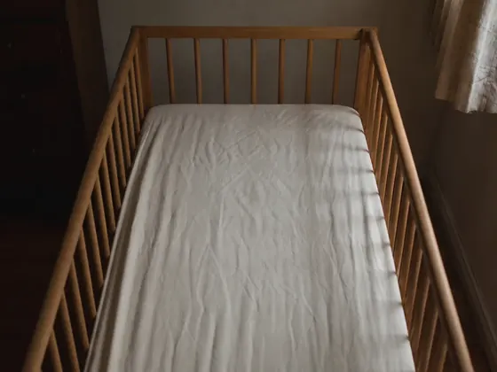 cot with a fitted sheet and nothing else