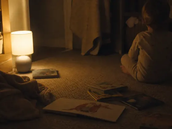 nursery floor, low lamp, bedtime books