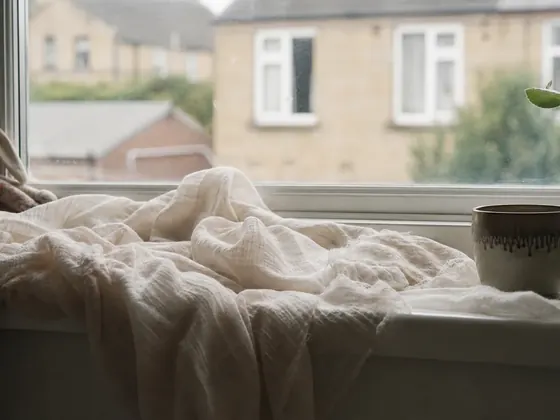 muslin cloths folded on a windowsill