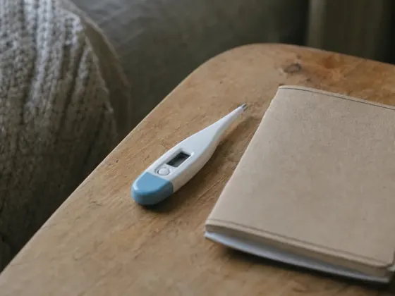 thermometer and a notebook on a table