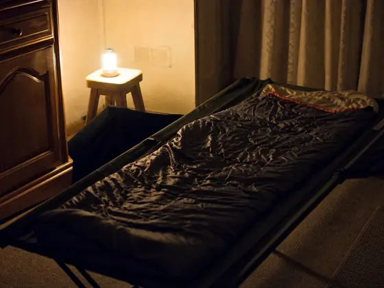 cot, sleeping bag, quiet room