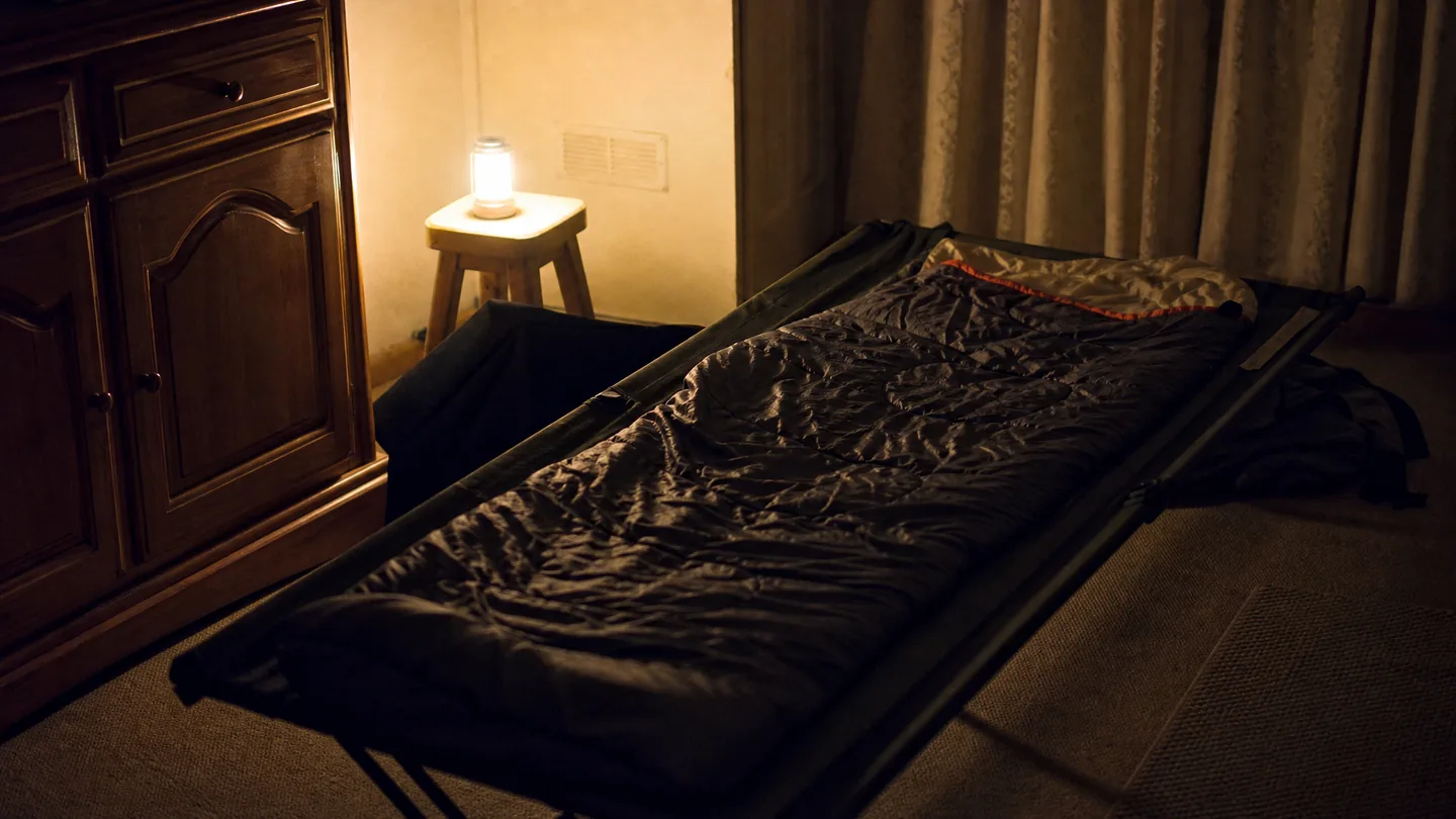 cot, sleeping bag, quiet room