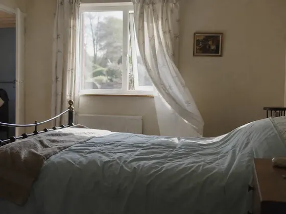 open window, morning light on a bed