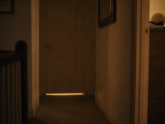 closed nursery door, hallway at night